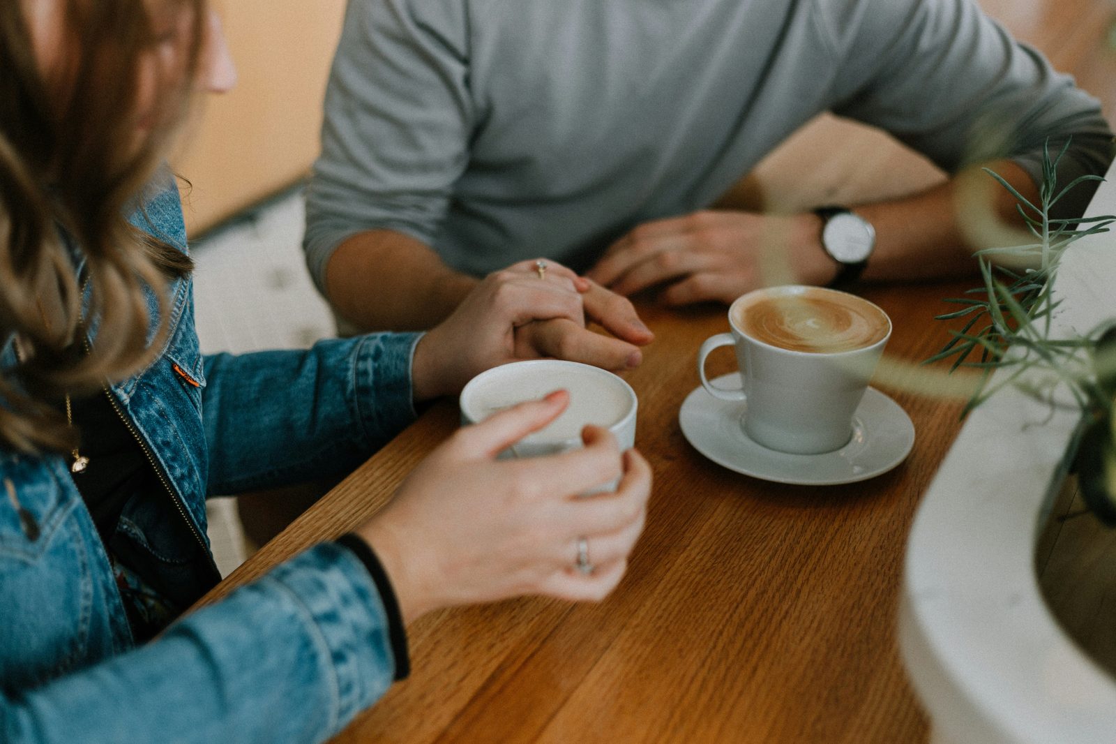 Two people sharing coffee across a table